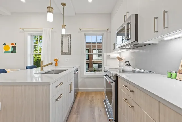a kitchen with a sink stove and cabinets