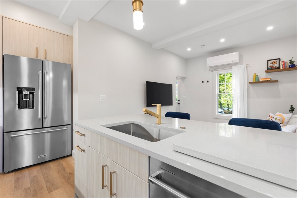 46 Lancaster Terrace, Unit 46 Brookline, MA 02446 - Photo 8 of 25 a kitchen with stainless steel appliances a refrigerator sink and microwave