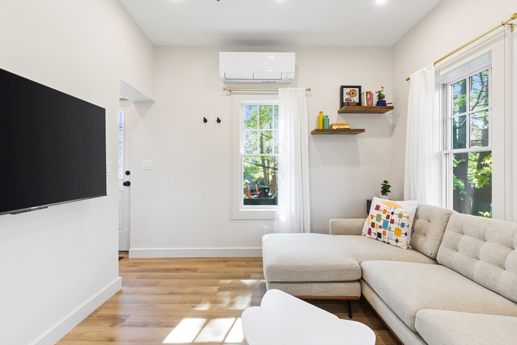 46 Lancaster Terrace, Unit 46 Brookline, MA 02446 - Photo 9 of 25 a living room with furniture and a flat screen tv