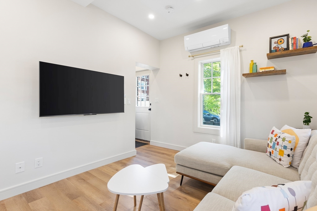 46 Lancaster Terrace, Unit 46 Brookline, MA 02446 - Photo 10 of 25 a living room with furniture and a flat screen tv
