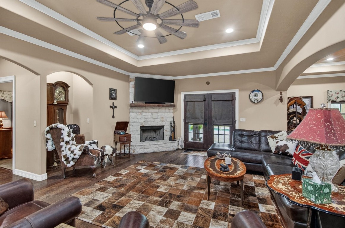 1755 McBride-Devillier Loop Winnie, TX 77665 - Photo 12 of 44 a living room with furniture a fireplace and a chandelier