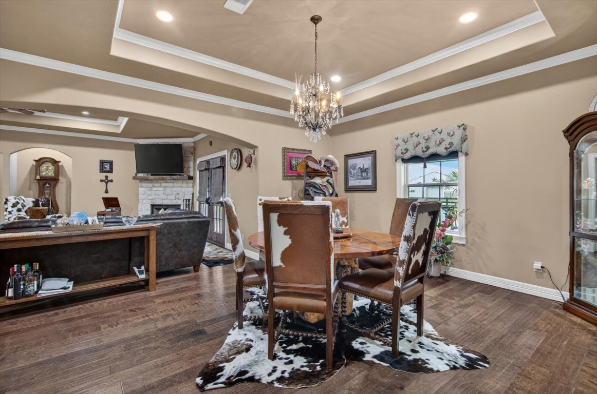 1755 McBride-Devillier Loop Winnie, TX 77665 - Photo 17 of 44 a view of a dining room with furniture and wooden floor