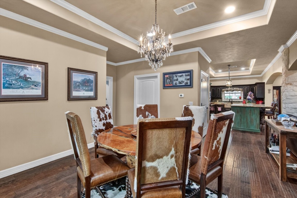 1755 McBride-Devillier Loop Winnie, TX 77665 - Photo 18 of 44 a view of a dining room with furniture and a chandelier