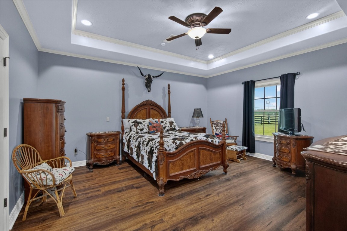 1755 McBride-Devillier Loop Winnie, TX 77665 - Photo 20 of 44 a bedroom with a bed and wooden floor