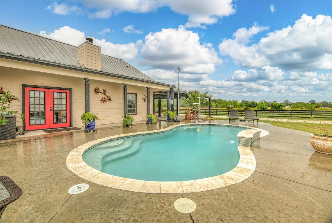 1755 McBride-Devillier Loop Winnie, TX 77665 - Photo 2 of 44 a view of a swimming pool with a yard