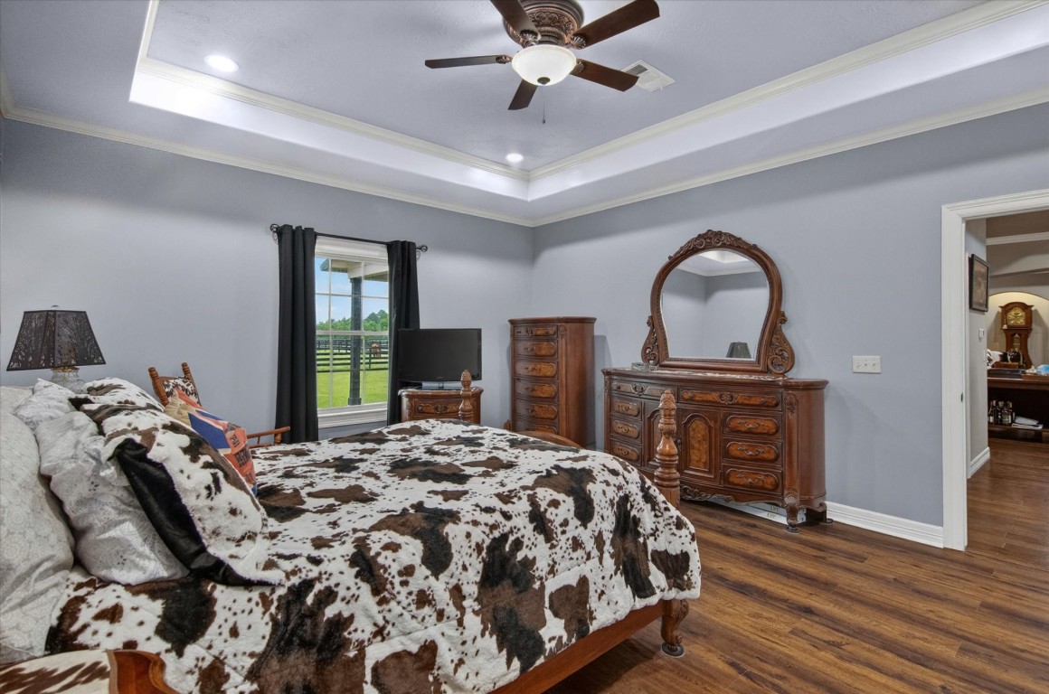1755 McBride-Devillier Loop Winnie, TX 77665 - Photo 21 of 44 a bedroom with a bed and a dresser with wooden floor