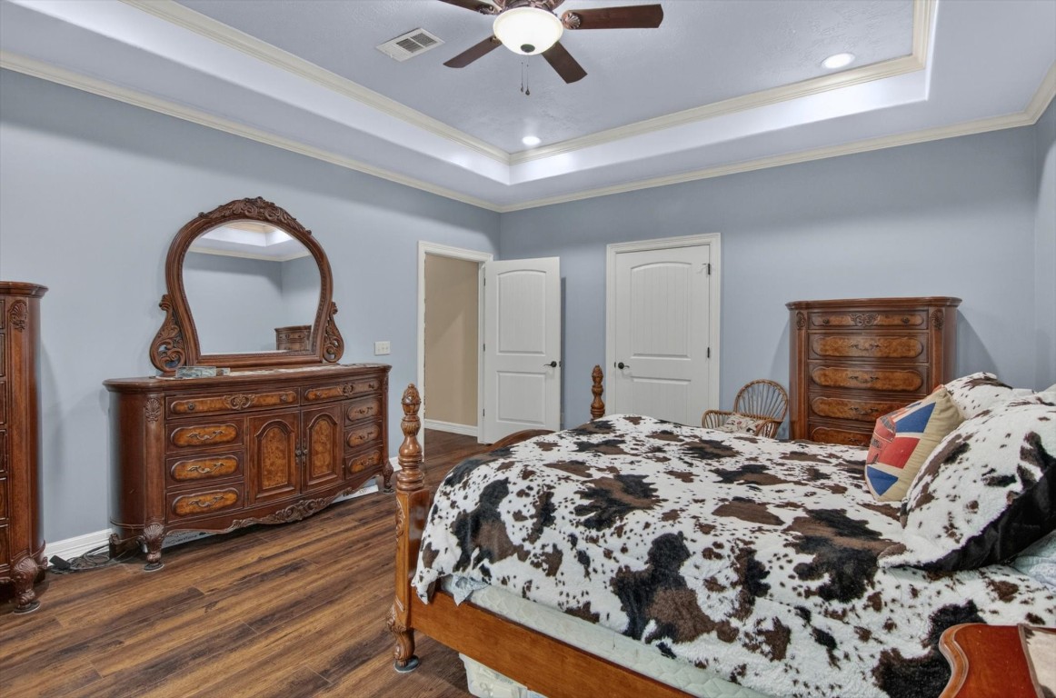 1755 McBride-Devillier Loop Winnie, TX 77665 - Photo 22 of 44 a bedroom with a bed and a dresser