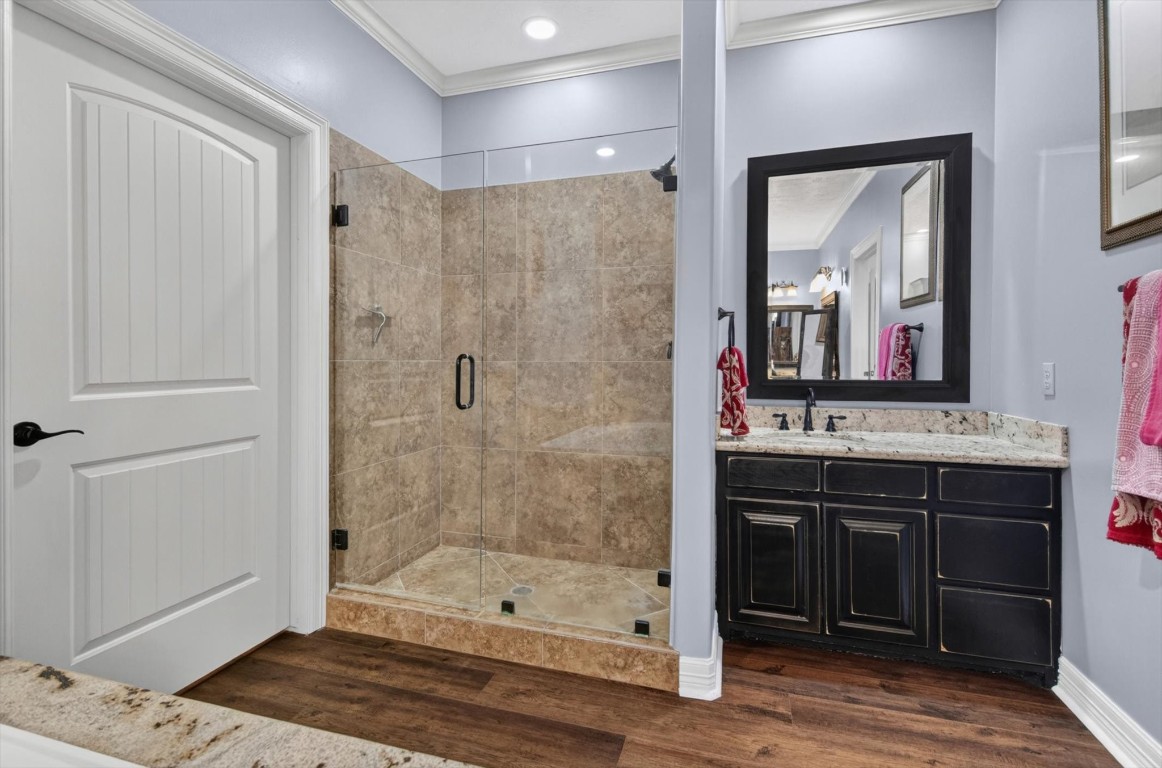 1755 McBride-Devillier Loop Winnie, TX 77665 - Photo 24 of 44 a bathroom with a sink a mirror and a shower