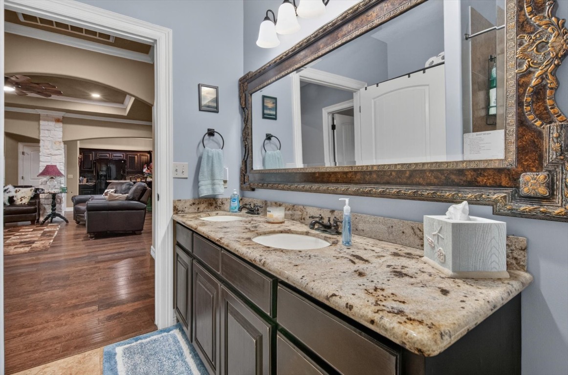 1755 McBride-Devillier Loop Winnie, TX 77665 - Photo 27 of 44 a bathroom with a granite countertop sink and a mirror