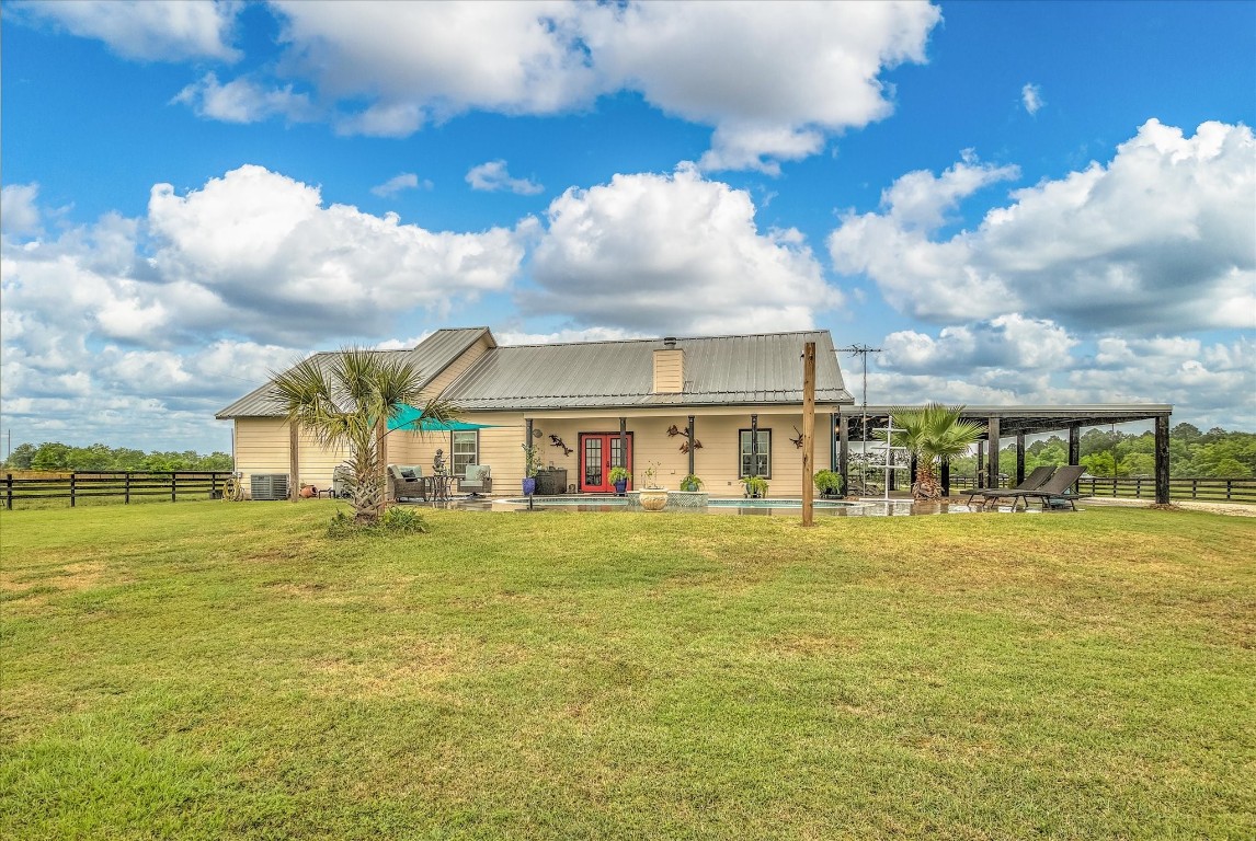 1755 McBride-Devillier Loop Winnie, TX 77665 - Photo 30 of 44 a view of a big house with a big yard and large trees