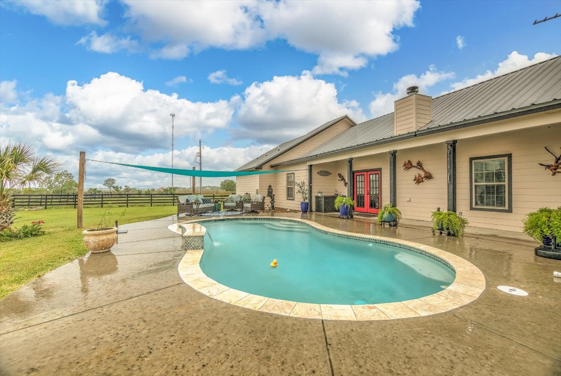 1755 McBride-Devillier Loop Winnie, TX 77665 - Photo 33 of 44 a view of a house with swimming pool and sitting area