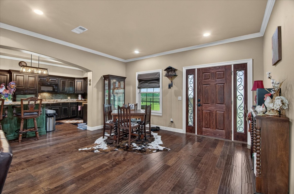 1755 McBride-Devillier Loop Winnie, TX 77665 - Photo 9 of 44 a view of a living room kitchen and hardwood floor