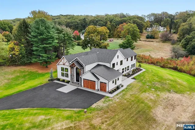 an aerial view of a house with a big yard