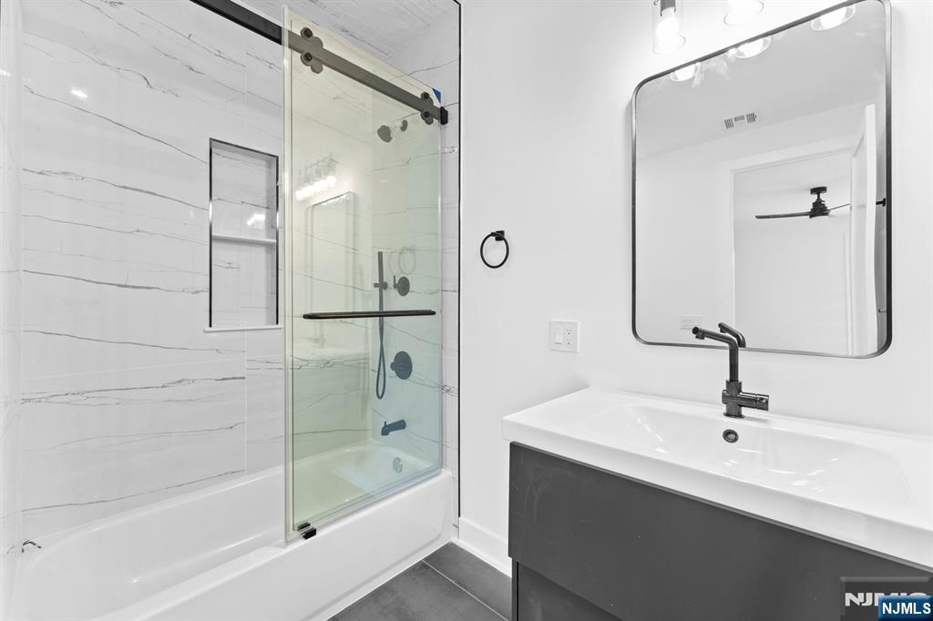 465 Cherry Lane Mendham, NJ 07945 - Photo 23 of 38 a bathroom with a bathtub shower sink and mirror