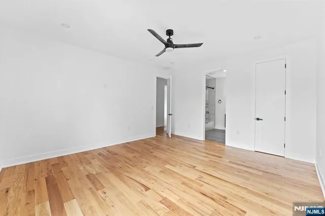a bathroom with a bathtub shower sink and mirror