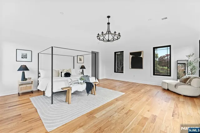 a dining room with furniture a chandelier and wooden floor