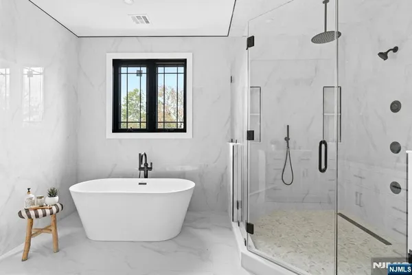 a bathroom with a white tub shower