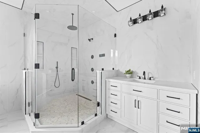 a bathroom with a shower sink and mirror