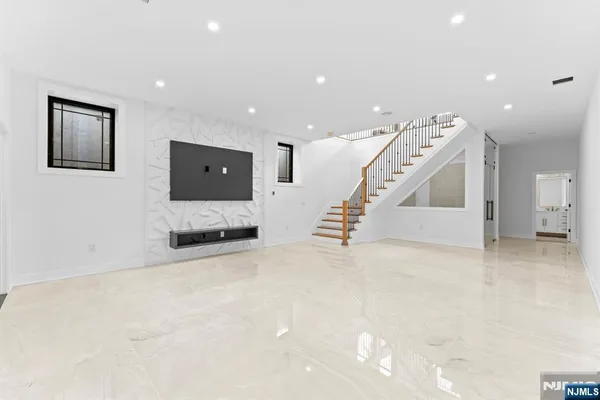 a view of entryway and hall with stairs