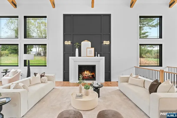 a living room with furniture fireplace and window