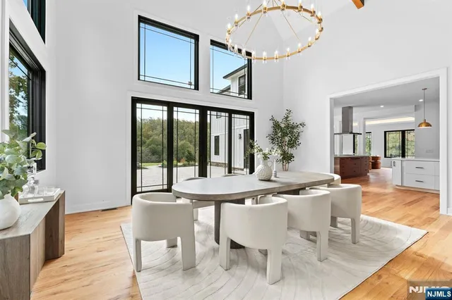 a dining room with furniture potted plants and a chandelier