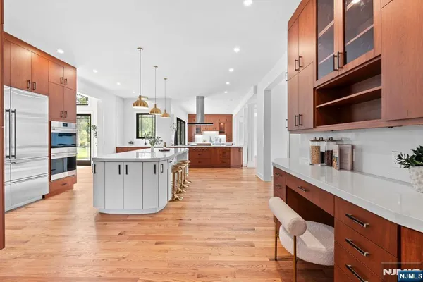 a living room with stainless steel appliances kitchen island granite countertop a refrigerator a stove top oven a sink and dishwasher