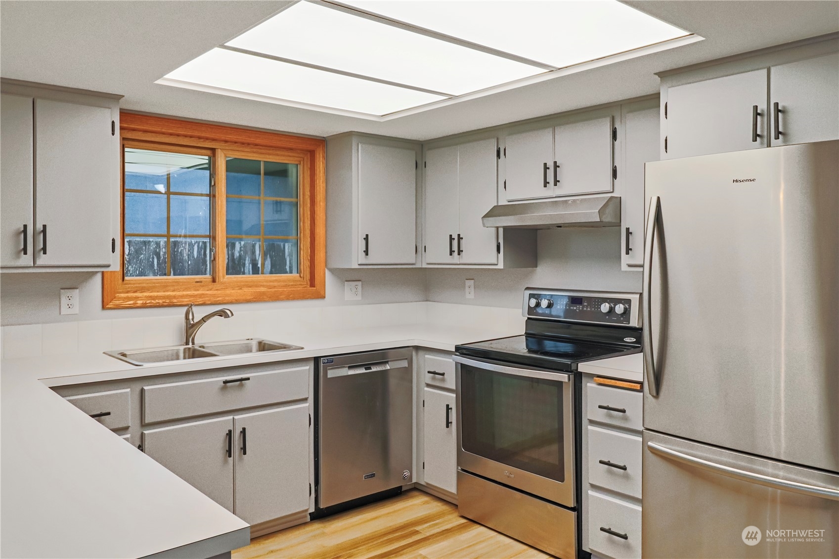 18237 Nutmeg Court Southwest Rochester, WA 98579 - Photo 11 of 34 a kitchen with stainless steel appliances a stove sink and refrigerator