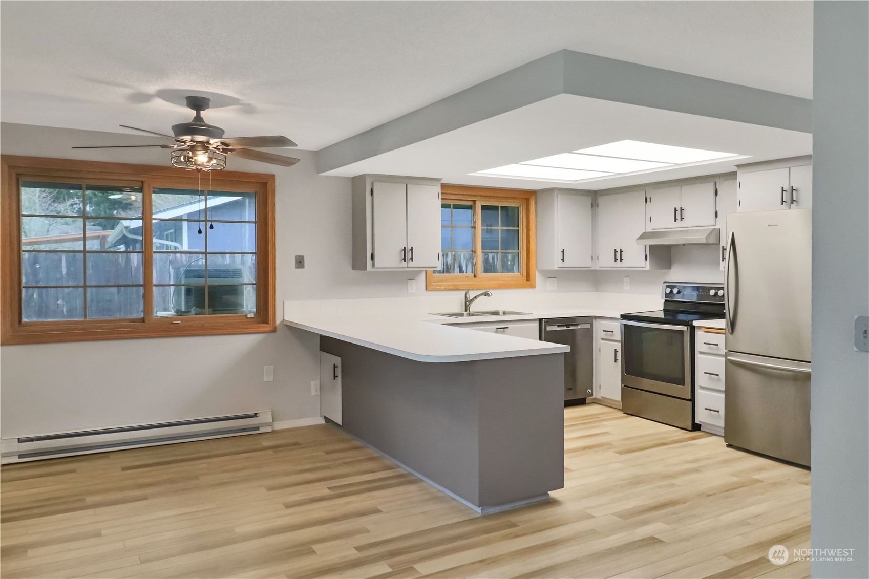 18237 Nutmeg Court Southwest Rochester, WA 98579 - Photo 12 of 34 a kitchen with stainless steel appliances kitchen island granite countertop a sink stove and refrigerator