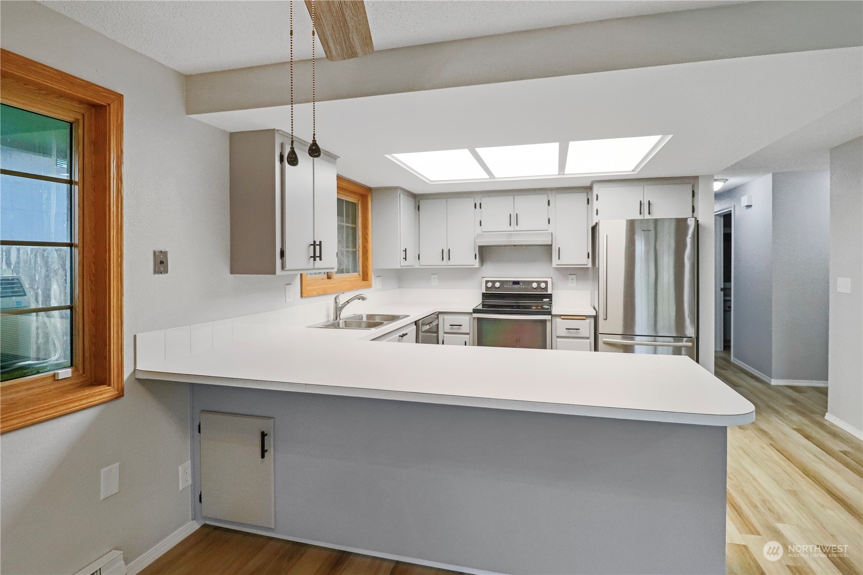 18237 Nutmeg Court Southwest Rochester, WA 98579 - Photo 13 of 34 a kitchen with stainless steel appliances a refrigerator and a stove top oven