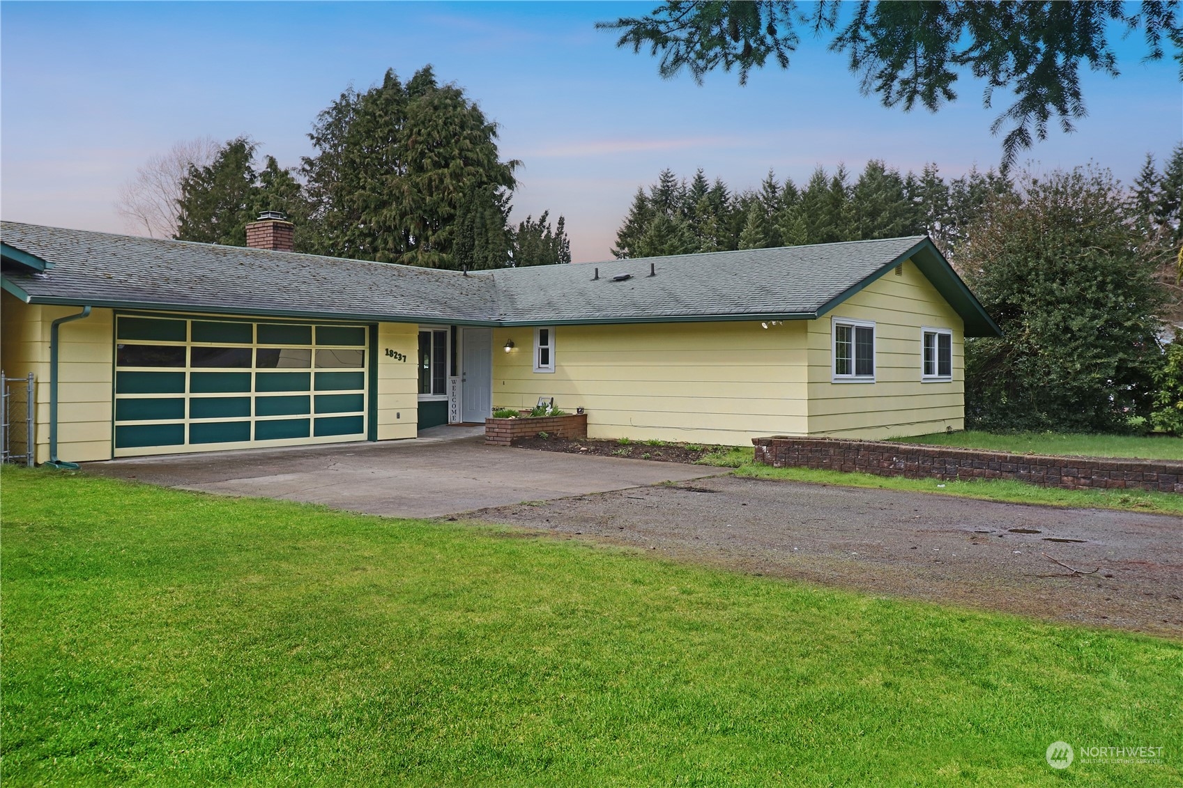 18237 Nutmeg Court Southwest Rochester, WA 98579 - Photo 2 of 34 a front view of a house with a garden