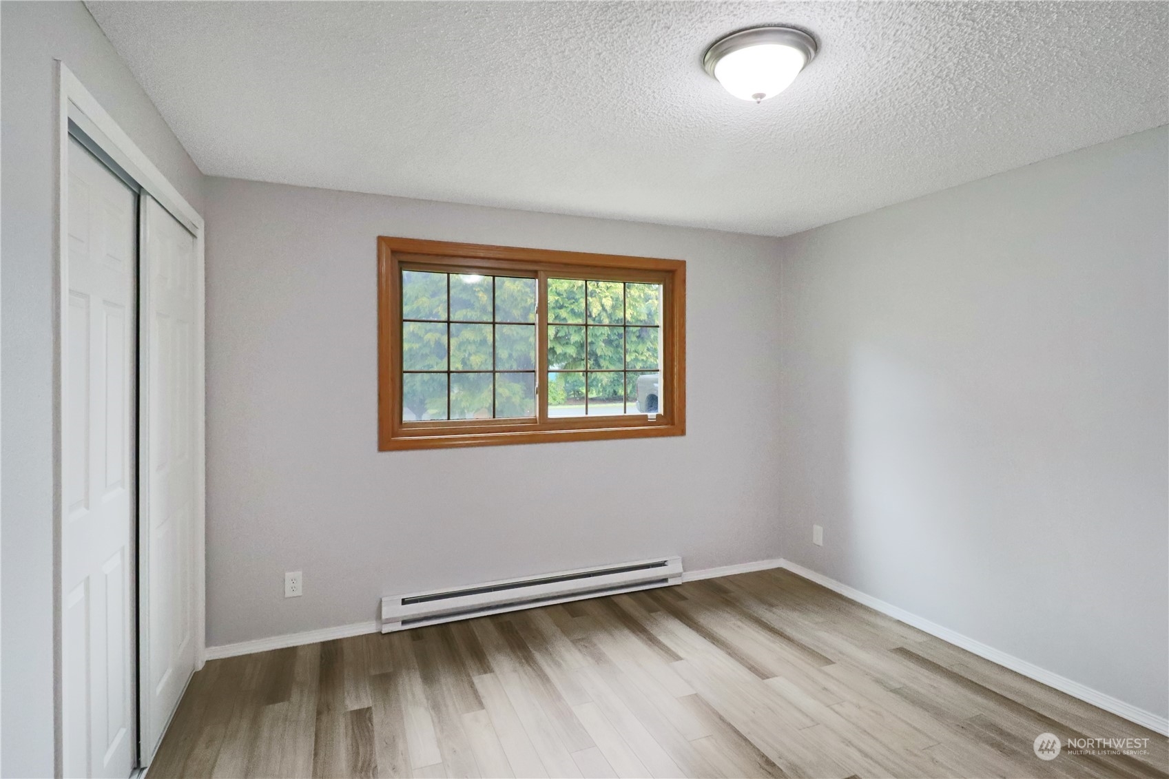 18237 Nutmeg Court Southwest Rochester, WA 98579 - Photo 24 of 34 an empty room with wooden floor and windows