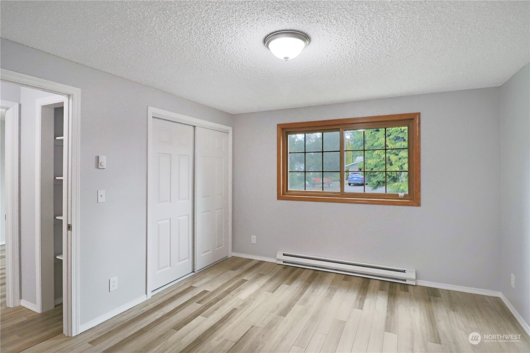 18237 Nutmeg Court Southwest Rochester, WA 98579 - Photo 26 of 34 an empty room with wooden floor and windows
