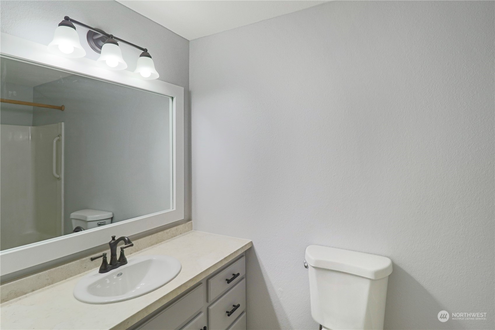 18237 Nutmeg Court Southwest Rochester, WA 98579 - Photo 28 of 34 a bathroom with a sink toilet a mirror and shower