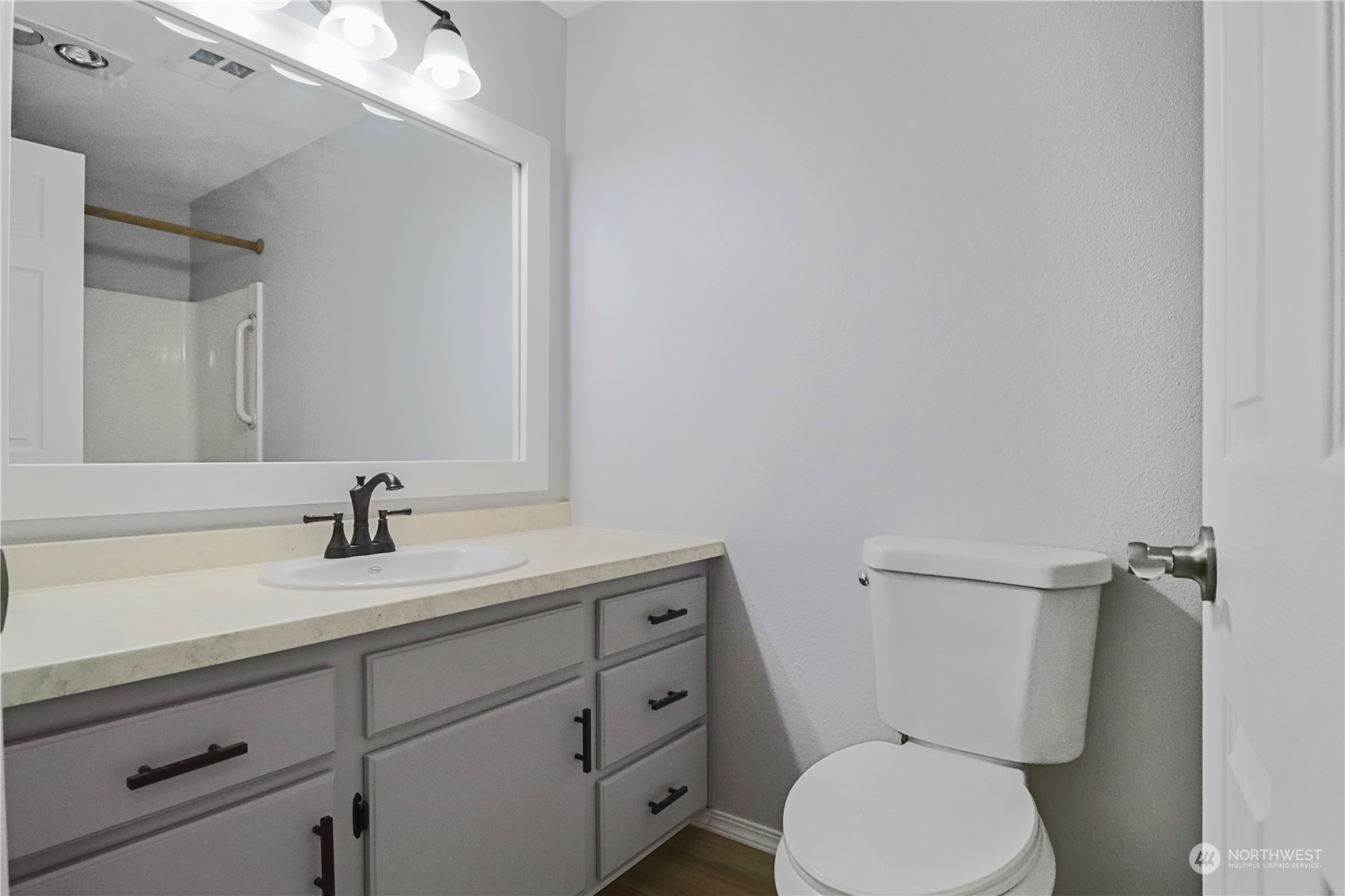 18237 Nutmeg Court Southwest Rochester, WA 98579 - Photo 29 of 34 a bathroom with a granite countertop toilet sink and mirror