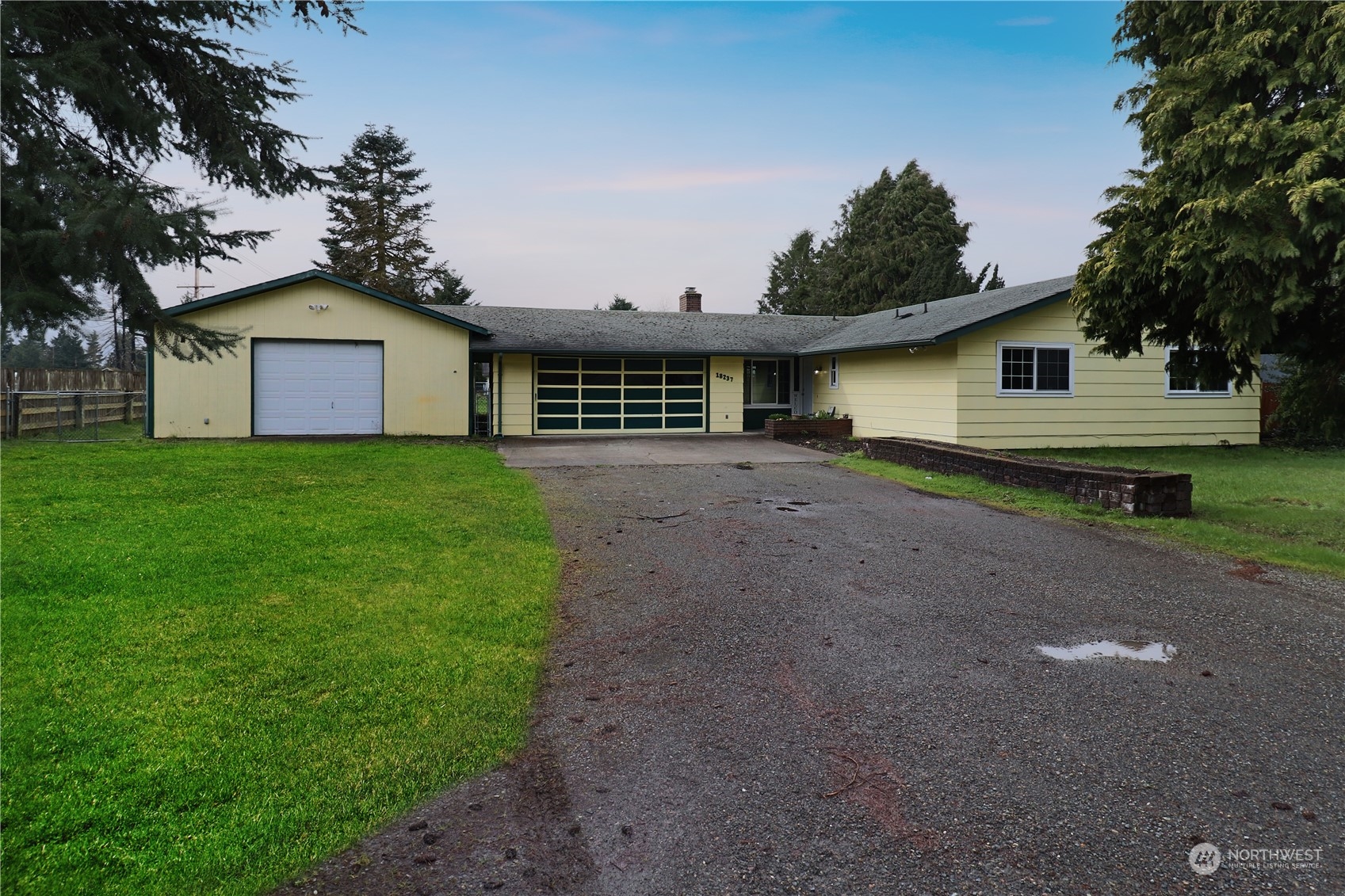 18237 Nutmeg Court Southwest Rochester, WA 98579 - Photo 3 of 34 a view of a yard in front of a house with large trees