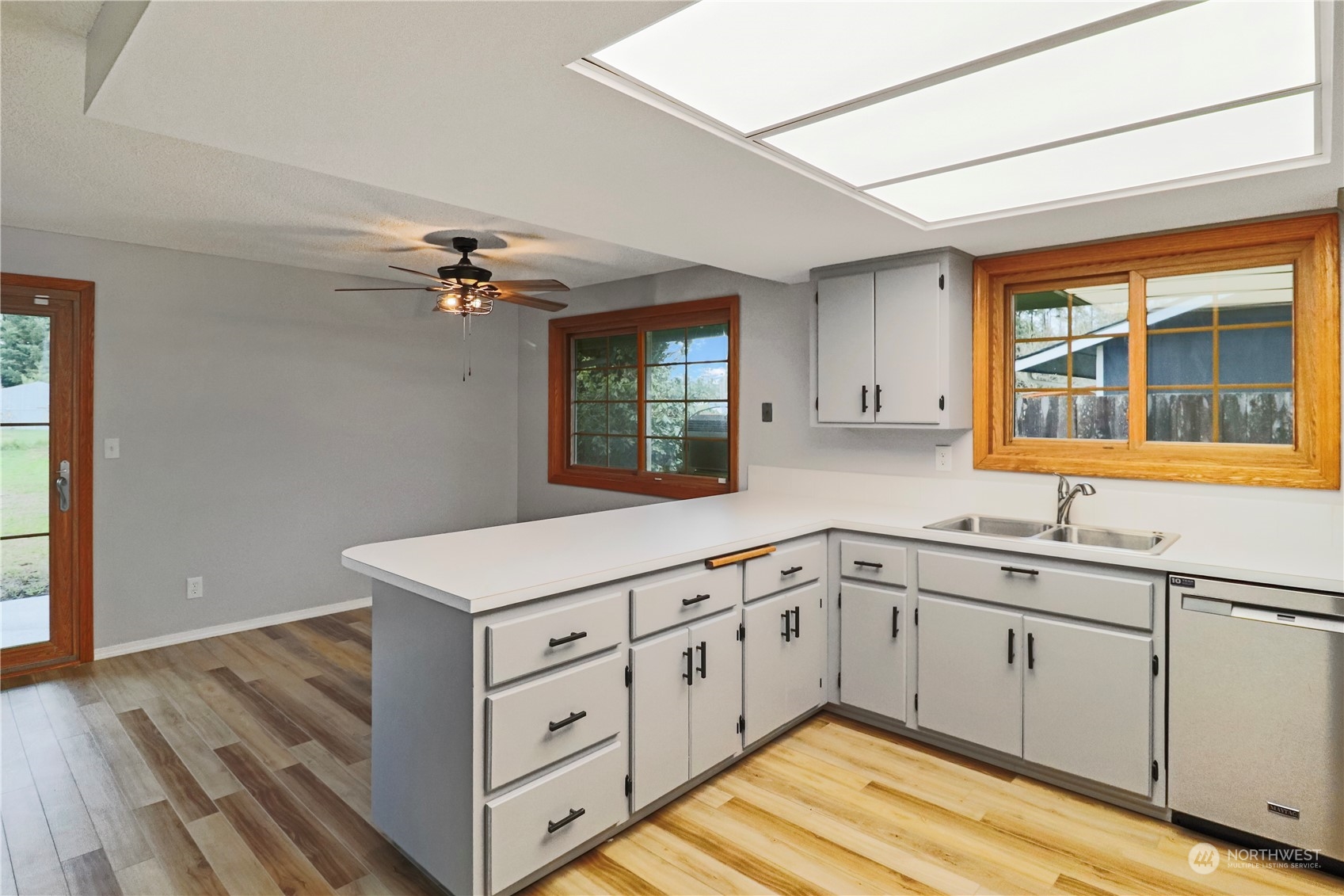 18237 Nutmeg Court Southwest Rochester, WA 98579 - Photo 10 of 34 a kitchen with granite countertop white cabinets and white appliances