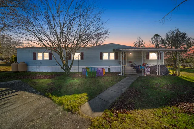 a view of house with a yard