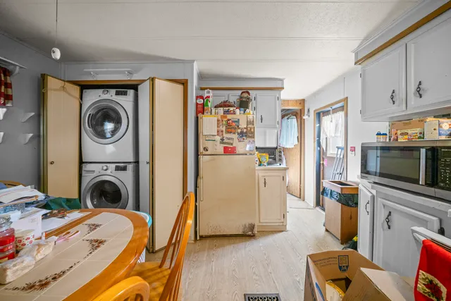 a open kitchen with stainless steel appliances granite countertop a refrigerator and stove top oven