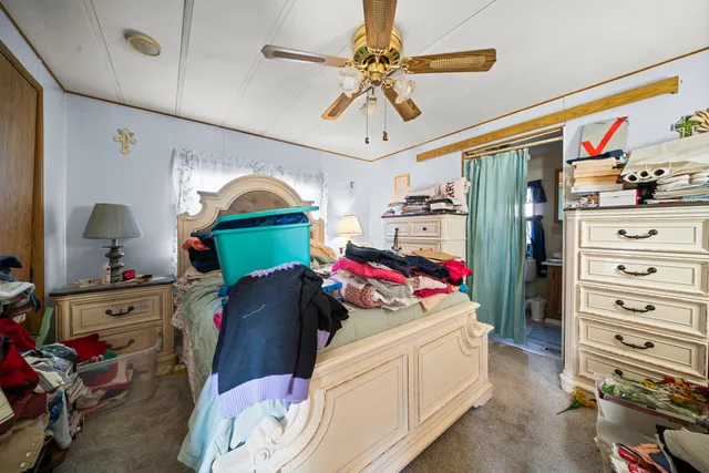 a bed room with a bed and a chair