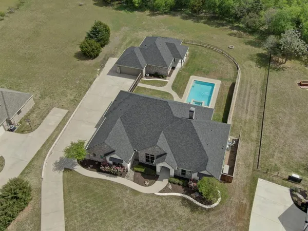 an aerial view of a house with a yard