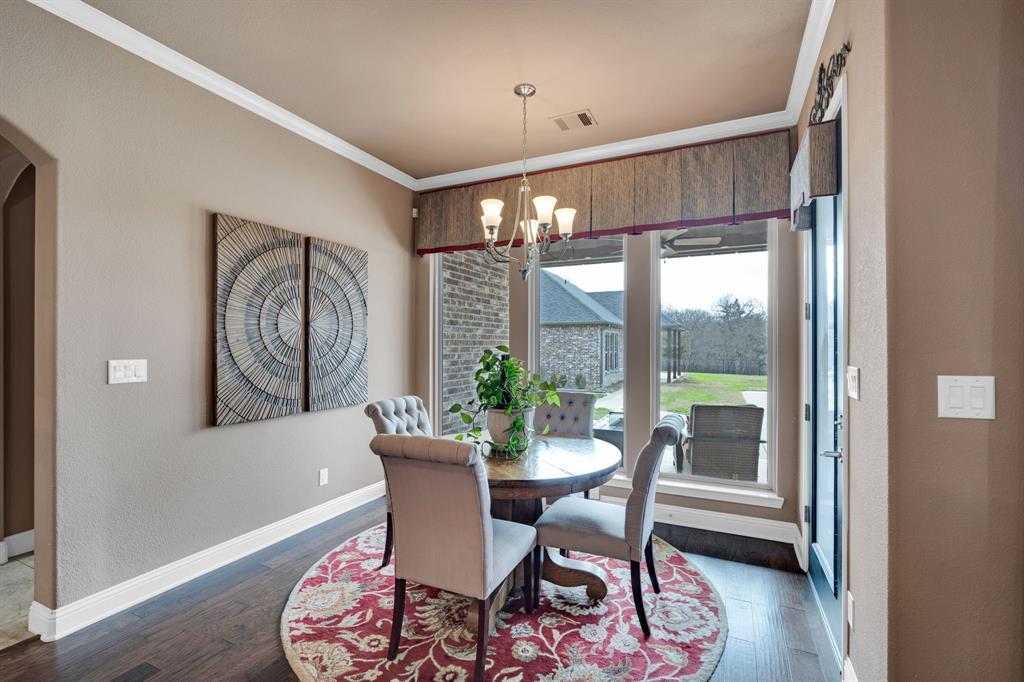136 Sullivan Way Waxahachie, TX 75167 - Photo 14 of 40 a dining room with furniture a chandelier and wooden floor