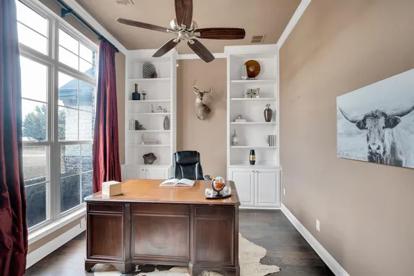 a view of a very nice looking dining room with a table and a large window