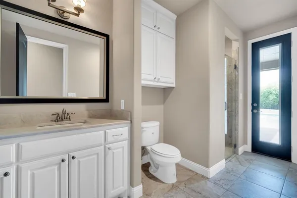 a bathroom with a toilet sink and mirror