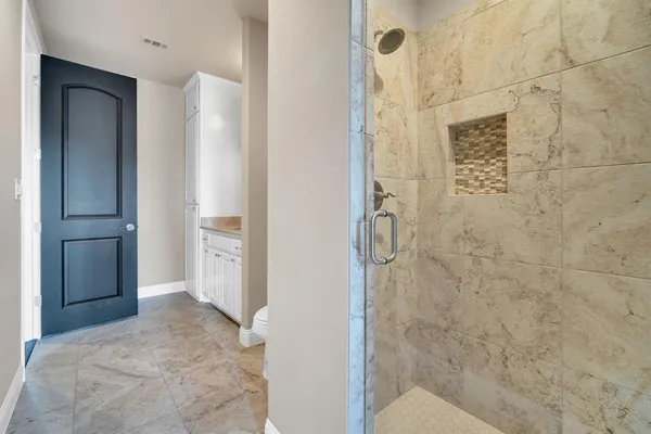 a bathroom with a shower and a sink