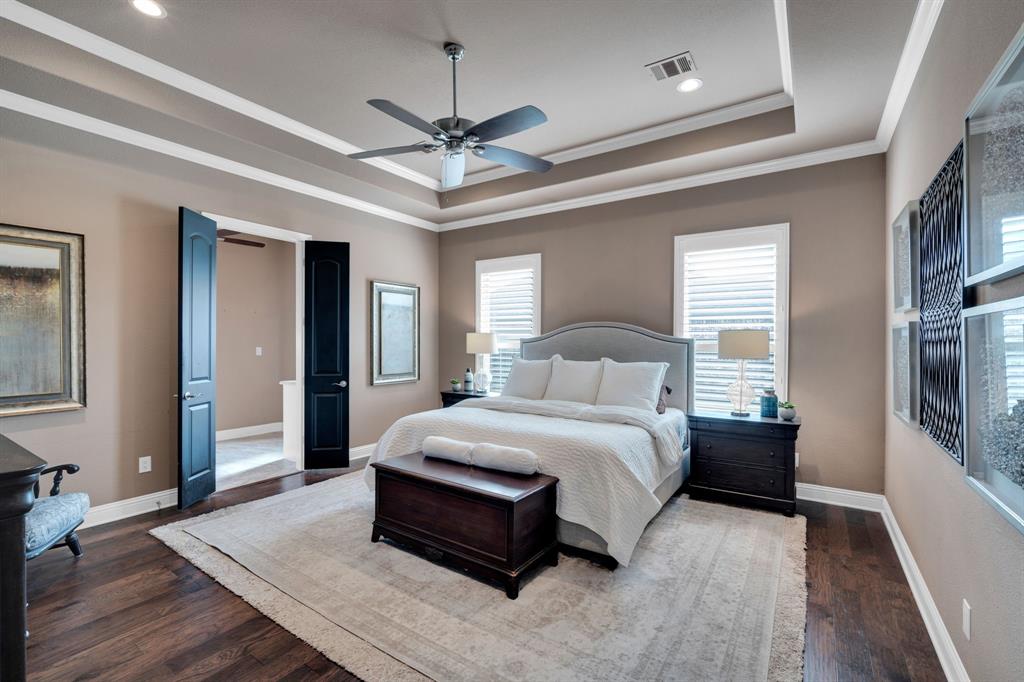136 Sullivan Way Waxahachie, TX 75167 - Photo 22 of 40 a bedroom with a large bed and a chandelier