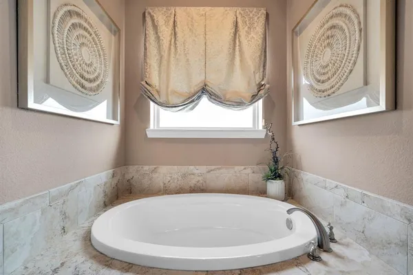 a bathroom with a bathtub and a window