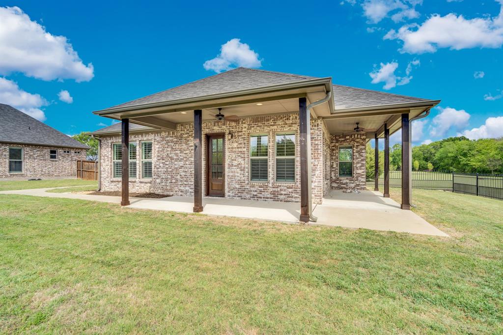 136 Sullivan Way Waxahachie, TX 75167 - Photo 30 of 40 a view of a house with backyard and porch