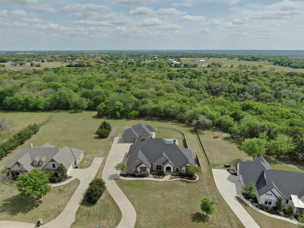136 Sullivan Way Waxahachie, TX 75167 - Photo 37 of 40 an aerial view of a house with a garden and lake view
