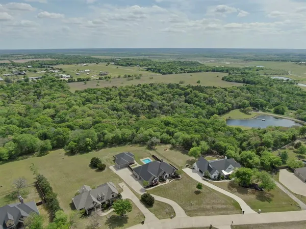 an aerial view of a houses with a yard
