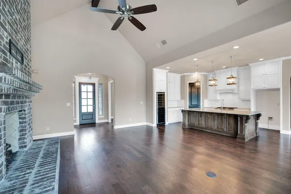 a view of an empty room with a window and fireplace